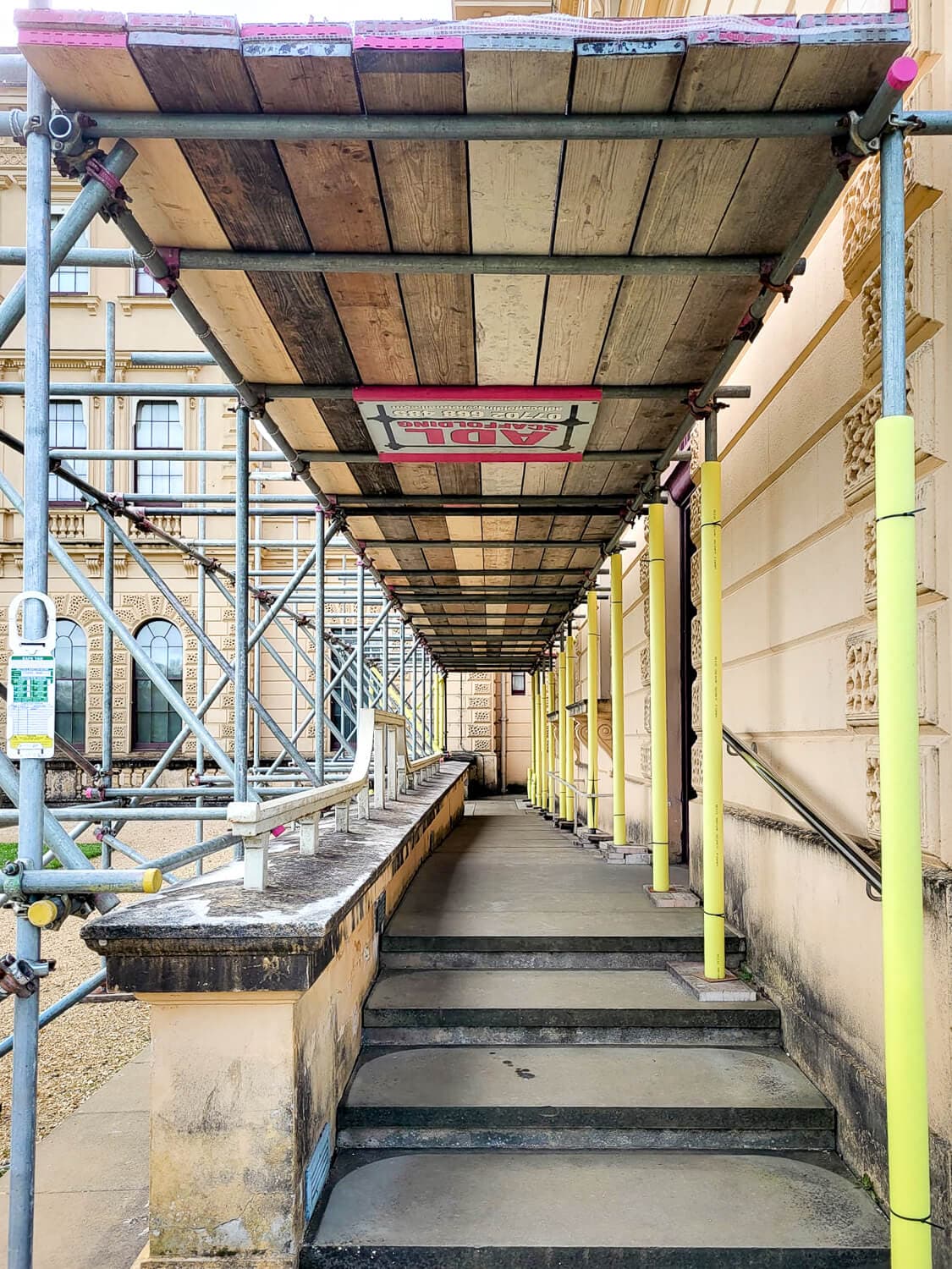 Protected pedestrian walkway scaffold alongside a grand stately home on the Isle of Wight