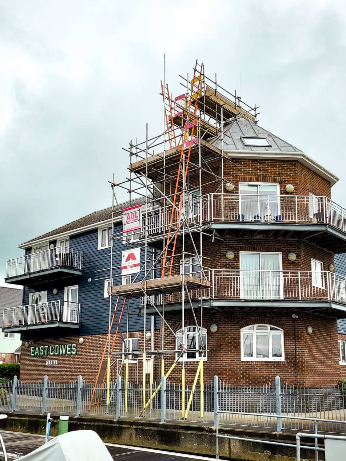 Scaffolding on a waterfront building at East Cowes Marina, Isle of Wight