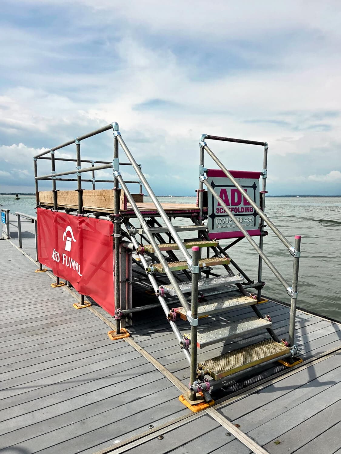 Marine scaffolding access platform on a dock with ADL Scaffolding branding, Isle of Wight