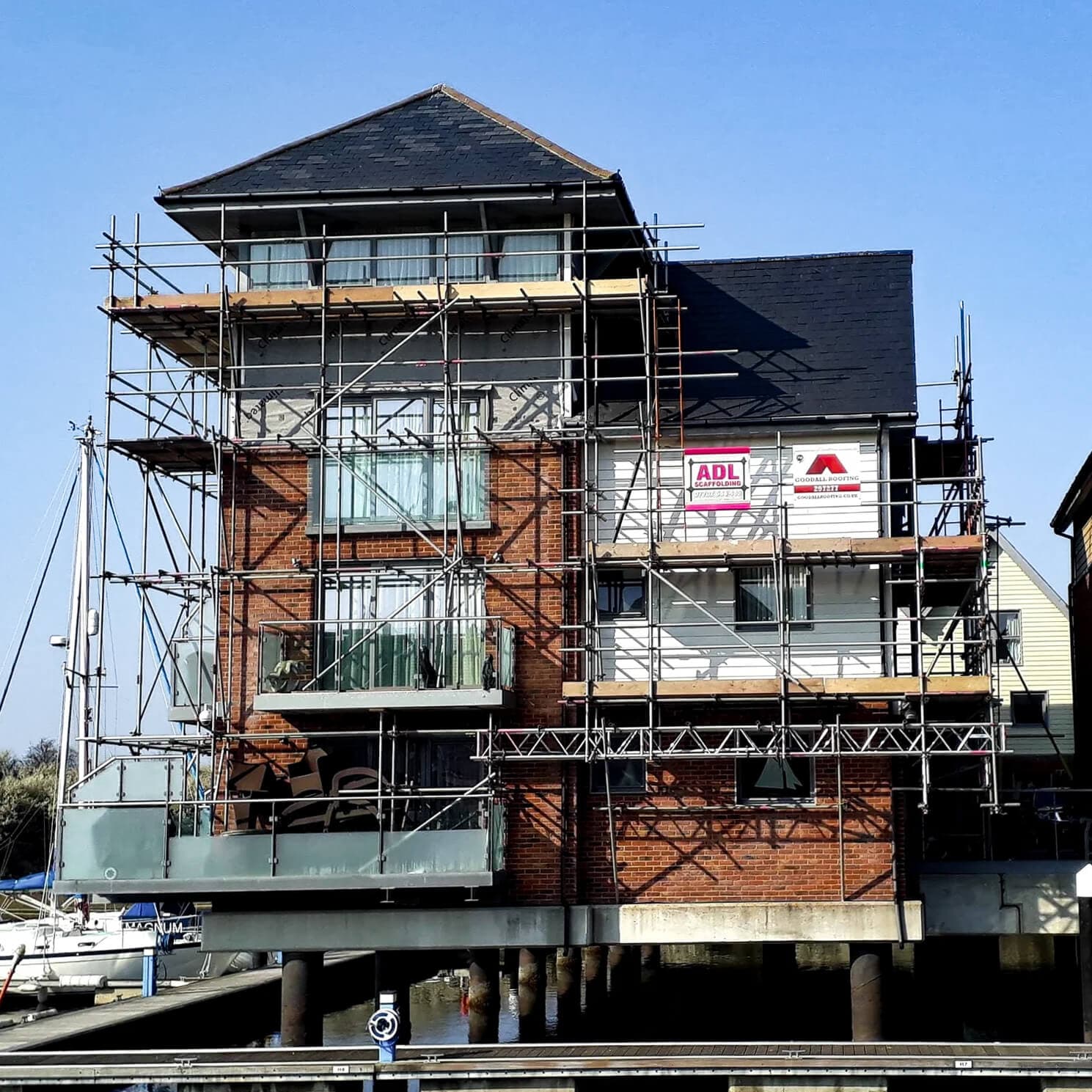 Scaffolding on a waterfront building at a marina, Isle of Wight