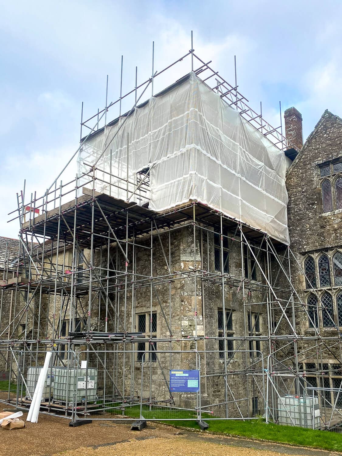 Full scaffolding and temporary shrink-wrap roof on a historic church building, Isle of Wight
